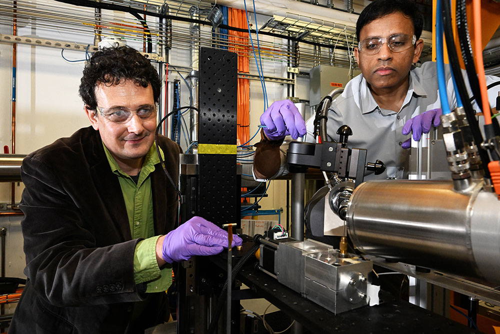 Emil Bozin (left) and Milinda Abeykoon (right) make experimental setup adjustments at the PDF beamline at NSLS-II.