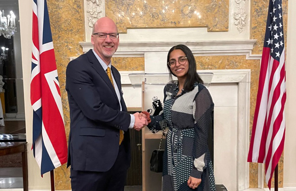 John Hill and Ruqaiyah Patel shaking hands in agreement