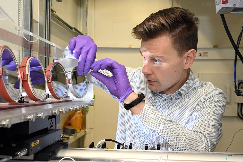 Image showing a scientist wearing purple gloves adjusting spectrometer