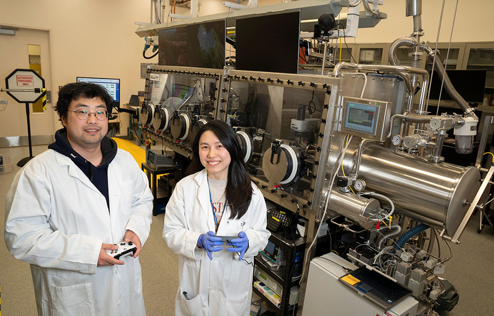 Houk Jang and Suji Park pose with the Q-Press at CFN