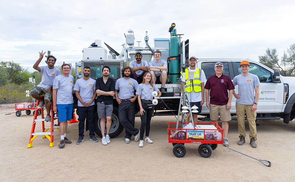 Project members and climate enthusiasts standing in front of the mobile observatory