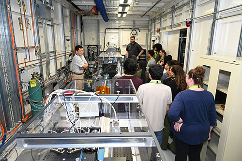 A group of students gathered around a beamline