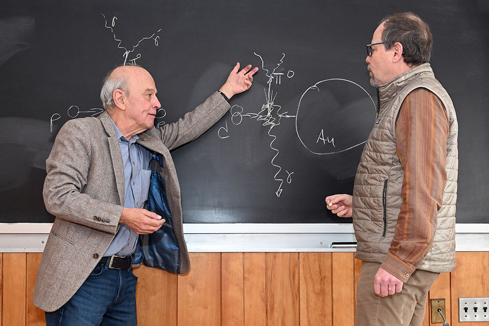 Gabor David and Axel Drees sketch on a chalkboard
