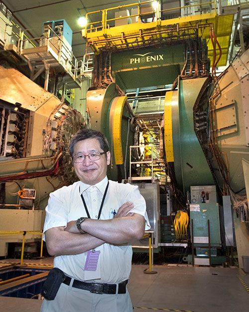 Yasuyuki Akiba stands before the PHENIX detector