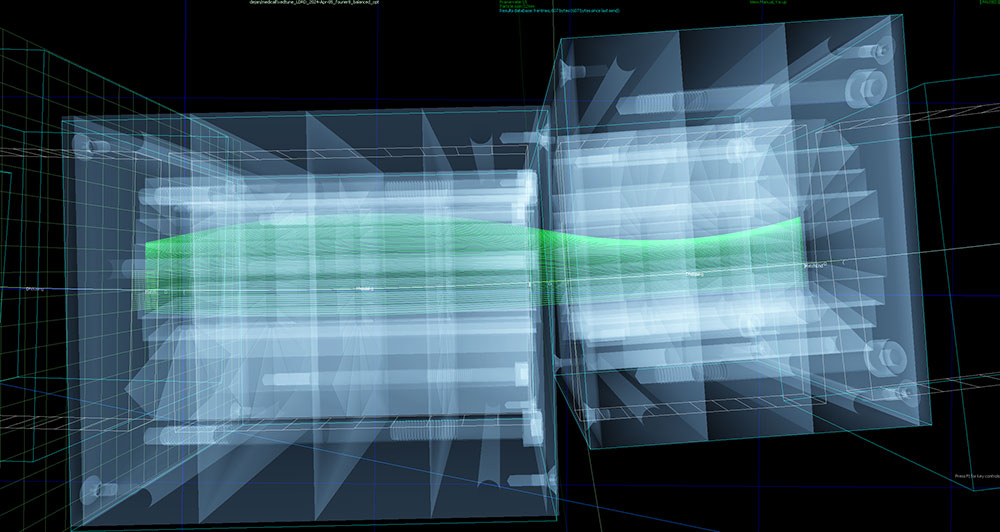 A simulation of the orbits of particle beams (green) moving through a transparent model of two magne