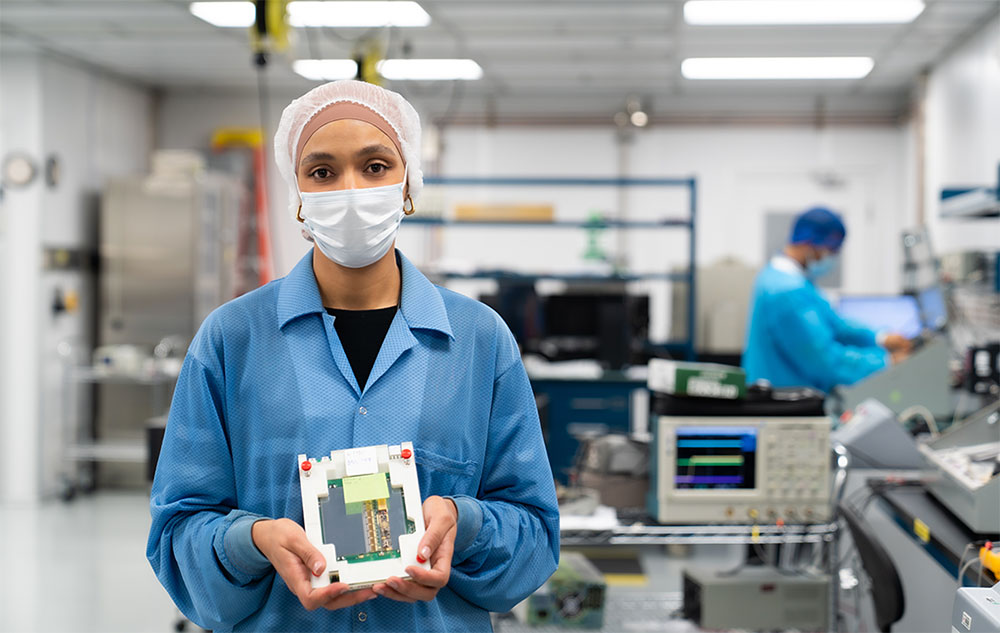 Mounia Laassiri holding detector components in a lab