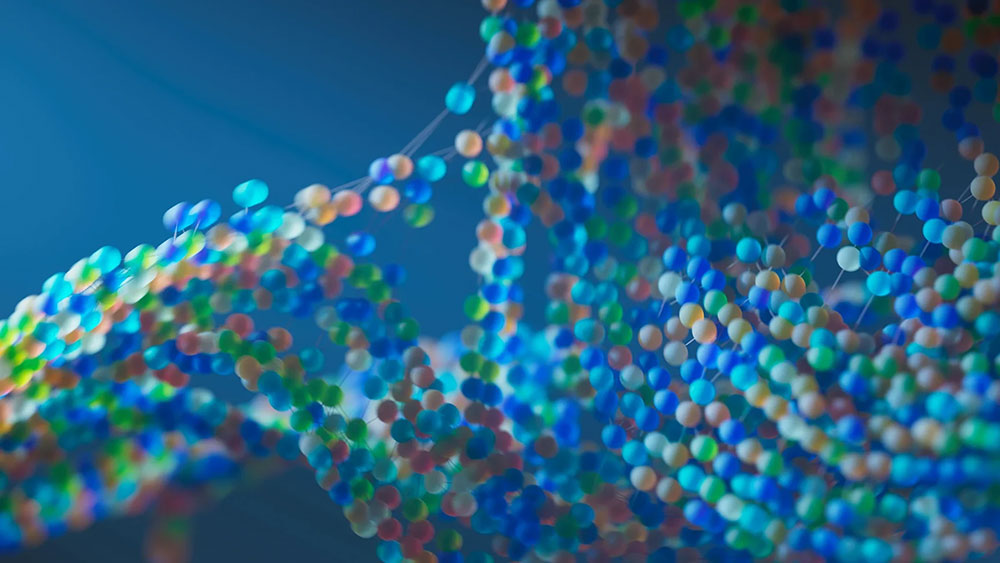 An abstract, macro shot of a blue, red, green, and orange beaded molecular structure, suggesting DNA