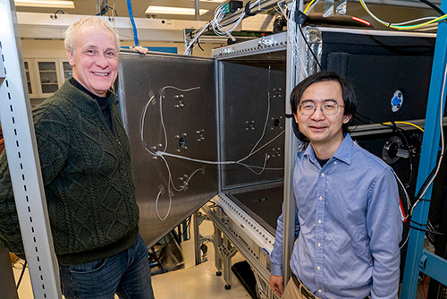 Atmospheric scientists Arthur Sedlacek (left) and Fan Yang in the cloud chamber laboratory, where th