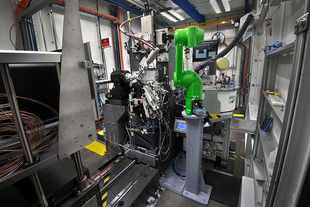 A robotic arm is positioned beside scientific instrumentation at the AMX beamline at the National Sy