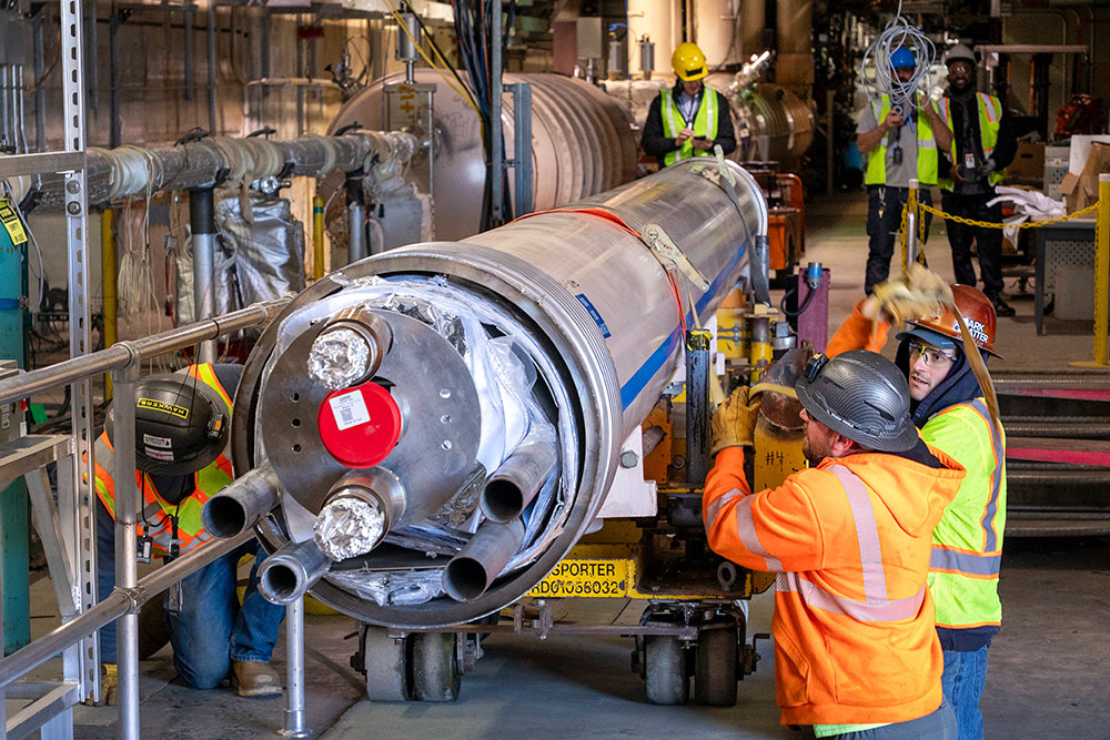 Technicians removing cryostat