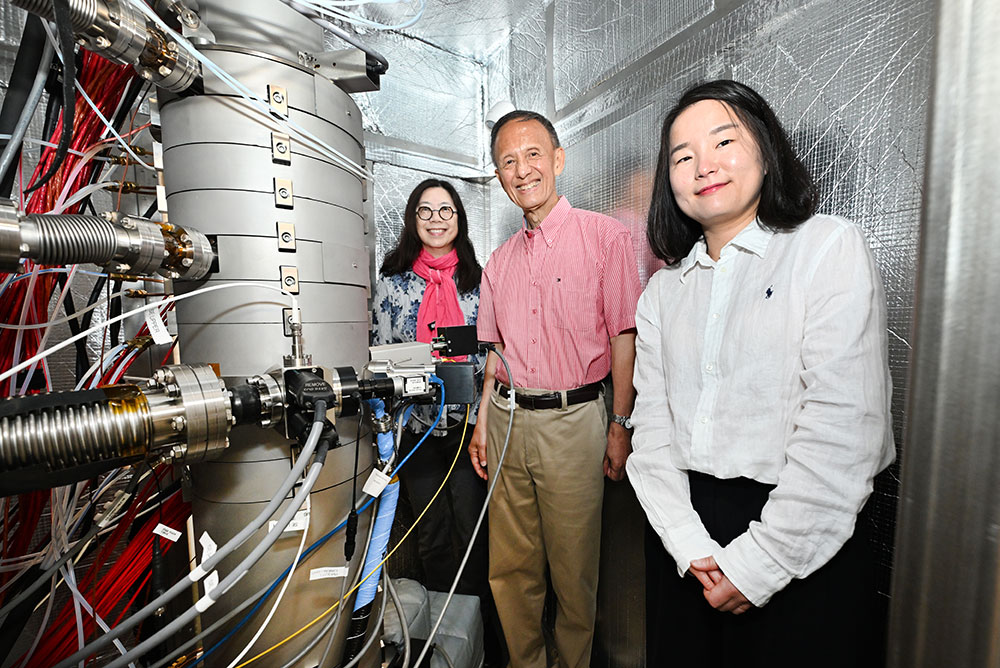 Judith Yang, Yimei Zhu, and Sooyeon Hwang stand with a new electron microscope