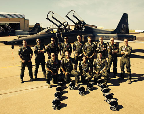 Jordan Ziegler (back row, second from right) poses with fellow students in front of a T-38 Talon dur