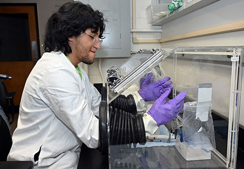 student practices using a glove box