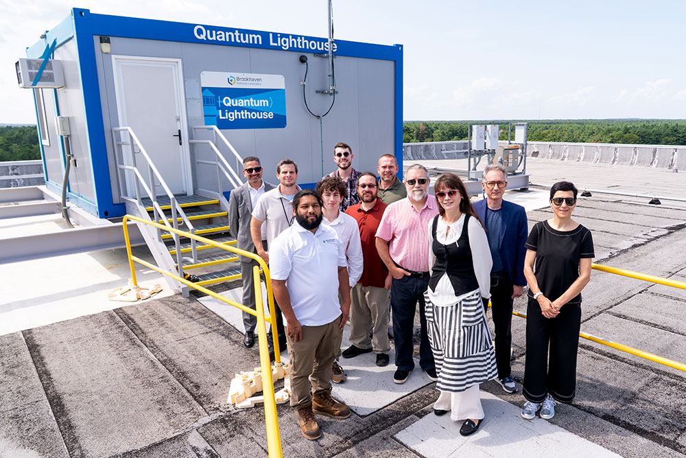 A Brookhaven Lab team of scientists, engineers, students, and leaders stand outside the Lab's Q