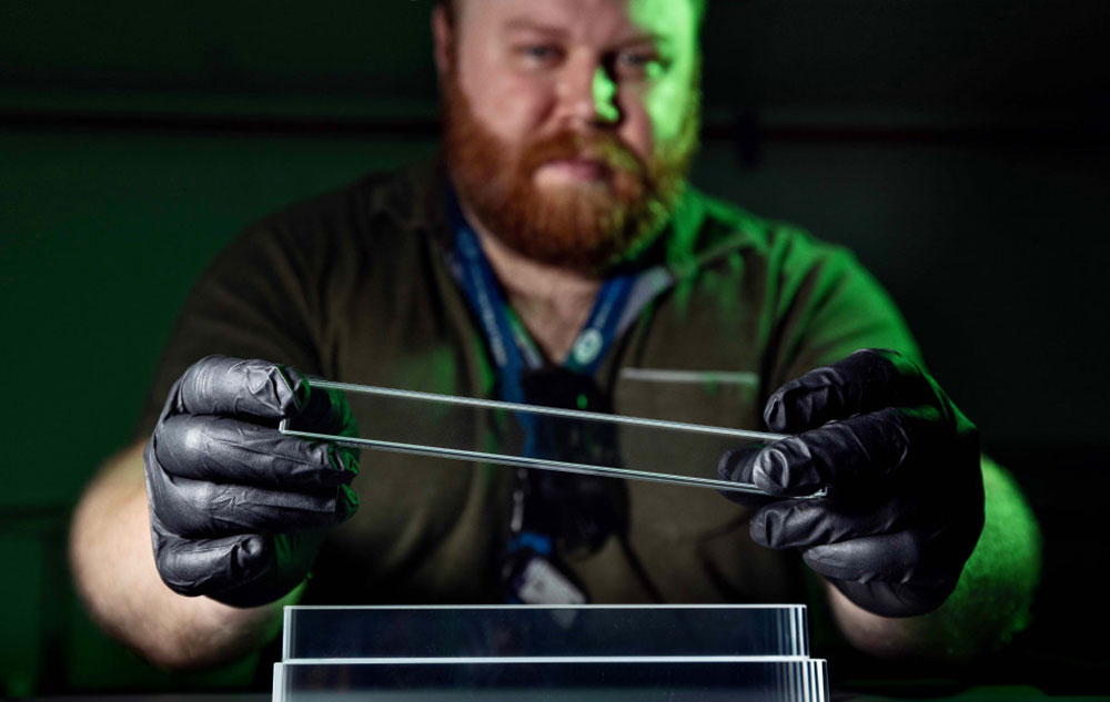 Joshua Crafts holds a lead-tungstate crystal