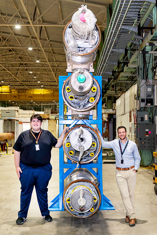 Brookhaven Lab summer intern Robert Desjardins (left) and his mentor, Electron-Ion Collider mechanic