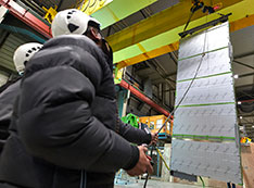 Photo of unpacking a particle detector device known as APA for testing at CERN