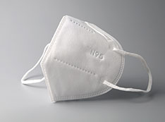Photo of white N95 mask on a gray background