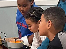 Scott Bronson engages participants from the Boys & Girls Club of the Shinnecock Nation in a less