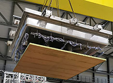 A crane lowers a charge readout plane attached to the top of the cryogenic vessel onto the vessel