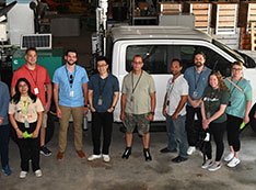 Program particpants pose for a group photo with mobile observatory