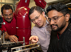 Sanjit Ghose, Enyuan Hu, Muhammad Mominur Rahman adjust beamline