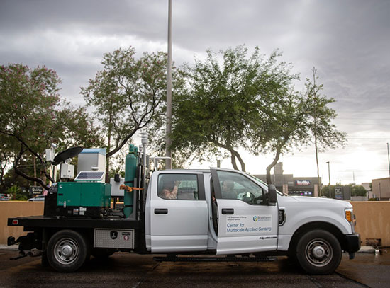 Mobile observatory truck against a gray, cloudy sky