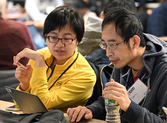 Two researchers working at a laptop