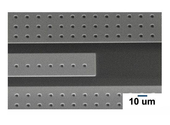 Perforating clean-limit Ta films with microfabricated holes suppresses vortex motion-induced microwa