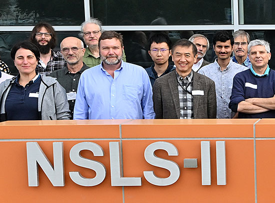 NSLS-II staff in front of NSLS-II sign
