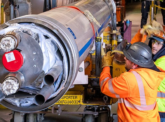 Technicians removing cryostat