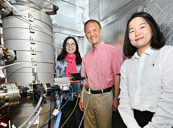 Judith Yang, Yimei Zhu, and Sooyeon Hwang stand with a new electron microscope