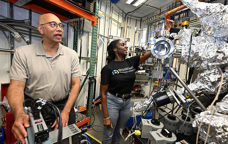 Kenneth Evans-Lutterodt and Tina Brower-Thomas with machinery