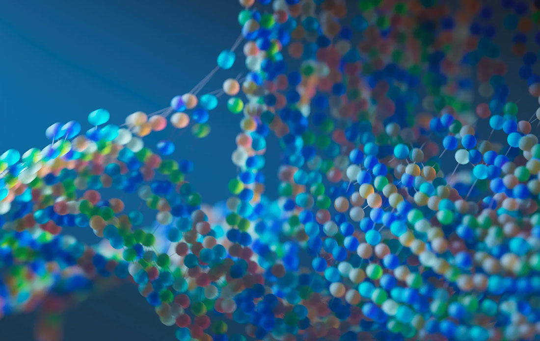 An abstract, macro shot of a blue, red, green, and orange beaded molecular structure, suggesting DNA
