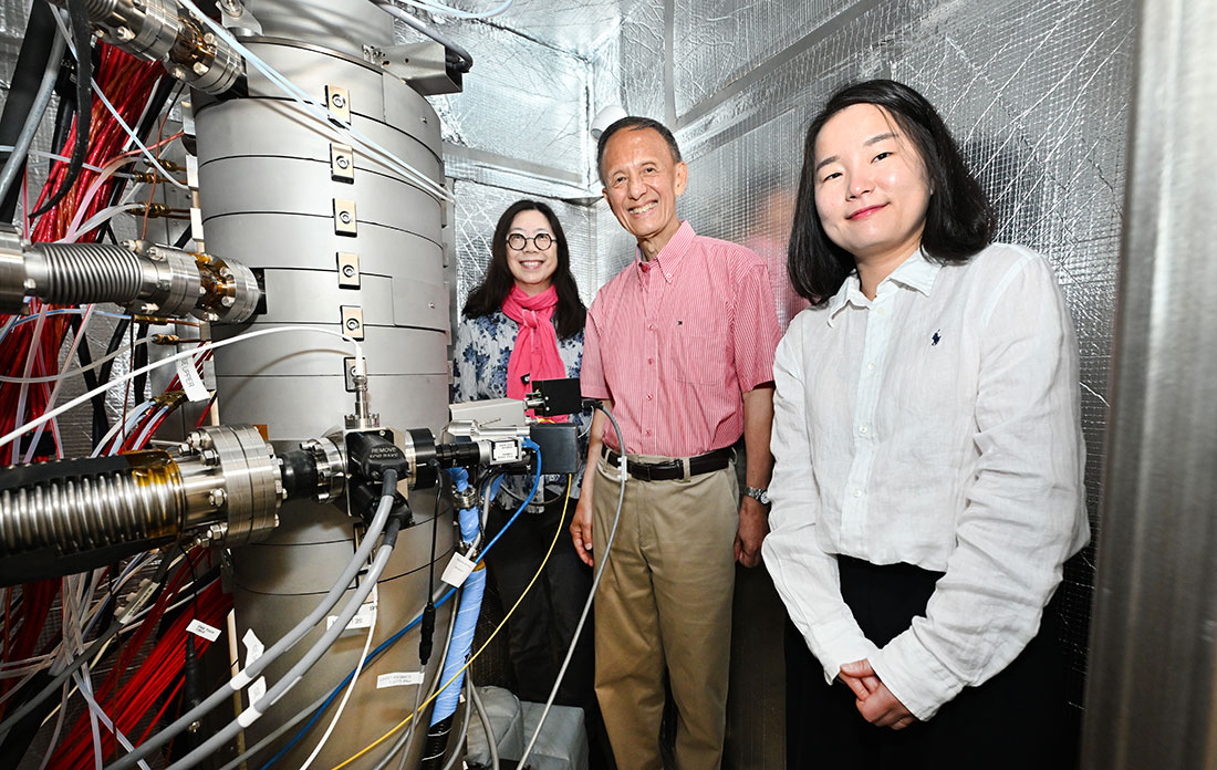 Judith Yang, Yimei Zhu, and Sooyeon Hwang stand with a new electron microscope