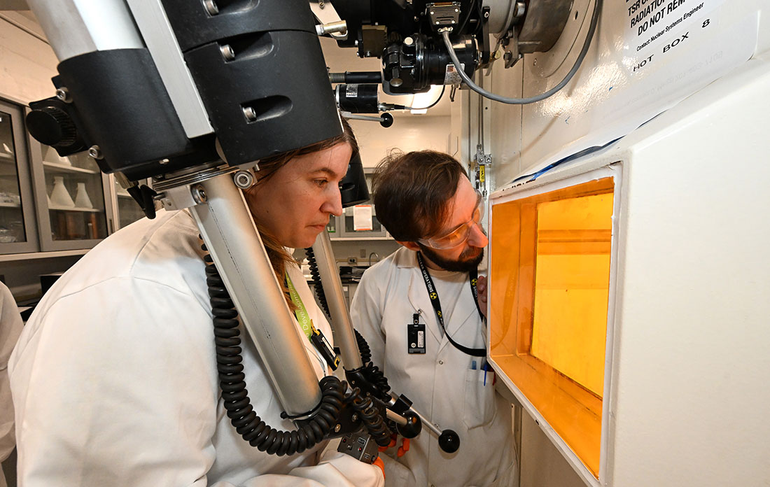 Arin Morton (left) simulates operating equipment in a hot cell facility