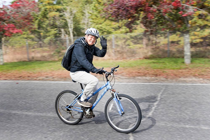 photo of cyclist waving to camera