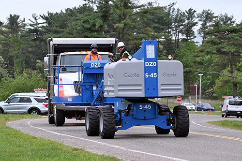 photo of workers driving in a self-propelled lift