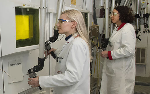photo of technicians processing medical isotopes in hot cells