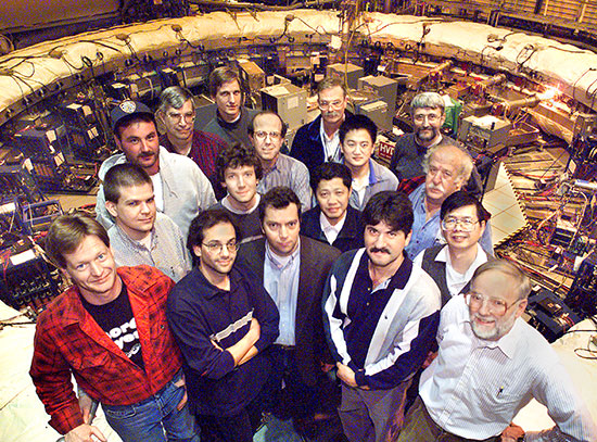 Members of the Brookhaven muon g-2 collaboration pose around the storage ring magnet in 2001.
